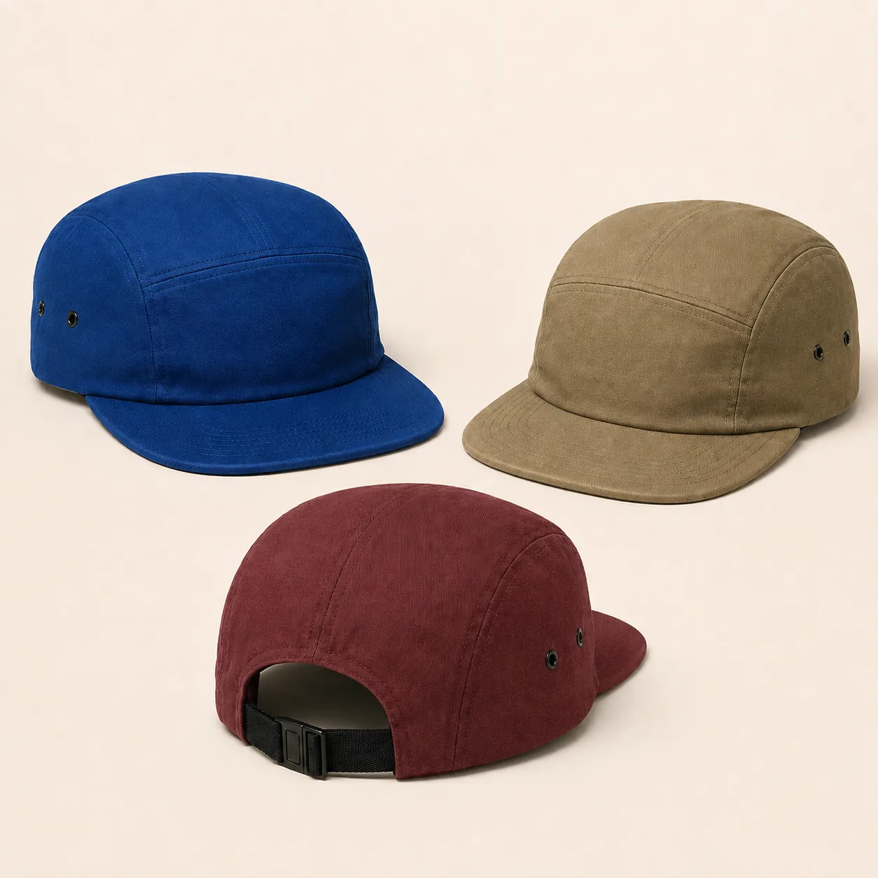 Blue, khaki and burgundy five-panel caps showing front panels and an adjustable rear strap