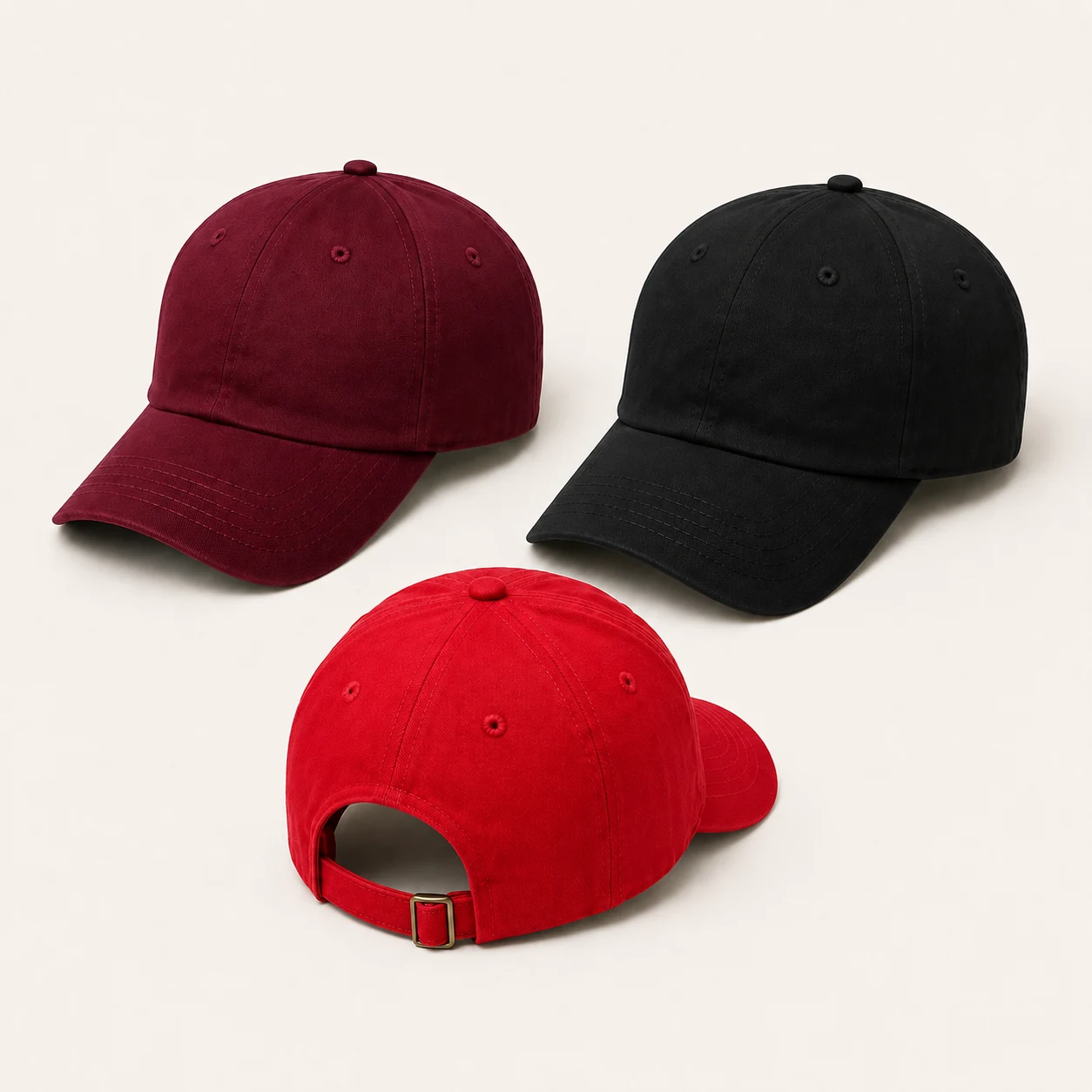 Burgundy, black and red six-panel caps with centre crown seams, curved visors and a buckle strap