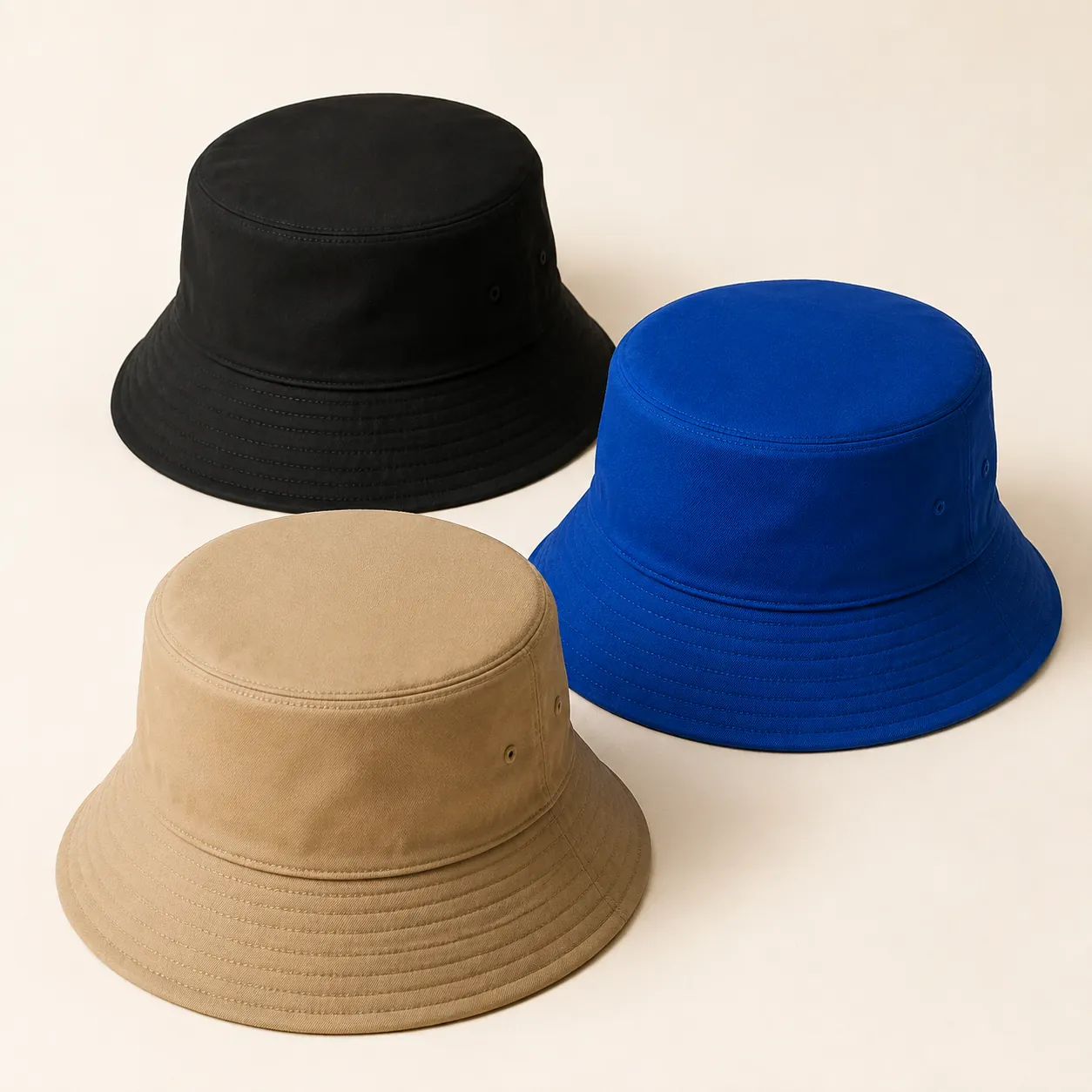 Black, blue and khaki bucket hats with flat crown tops and stitched all-around brims