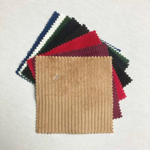 Layered corduroy fabric swatches in tan, red, black, green and blue