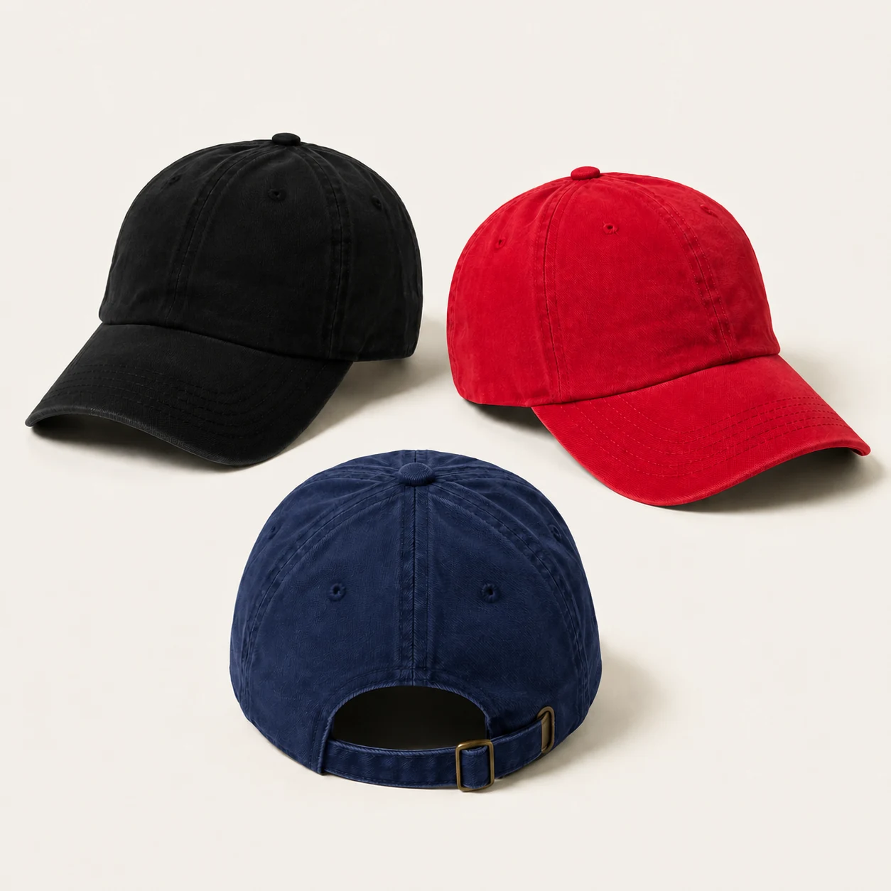 Black, red and navy dad hats with curved visors and an adjustable buckle strap