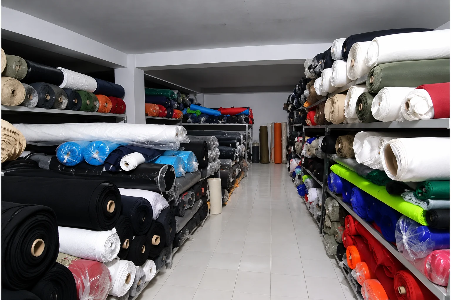 Organized fabric rolls on shelves inside the Wenext Caps factory storage room